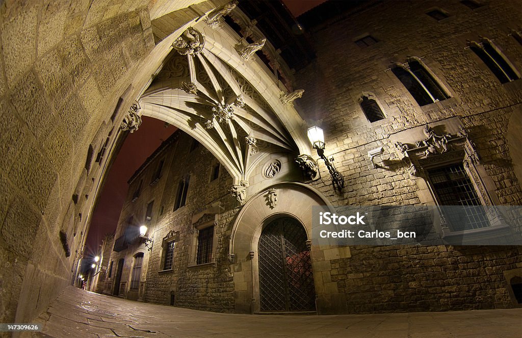 Carrer del Bisbe at night The Carrer del Bisbe street is one of the most popular venues of the gothic quarter of Barcelona, just a few dozens of meters away from the gothic cathedral. In this area, the streets are narrow and old - at night-time, they look even more mysterious and magical. Barcelona - Spain Stock Photo