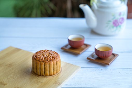 Moon cake served with chinese tea. Mid-autumn festival concept. Copy space.