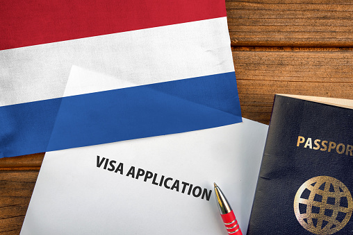 Visa application form, passport and flag of Netherlands