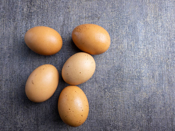 istock Close up fresh organic chicken eggs in grey background. Egg copyspace 1473099236