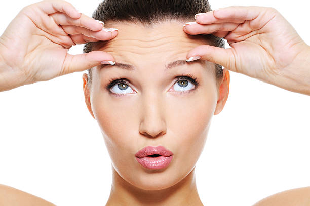 female face with wrinkles on her forehead - skrynklig bildbanksfoton och bilder