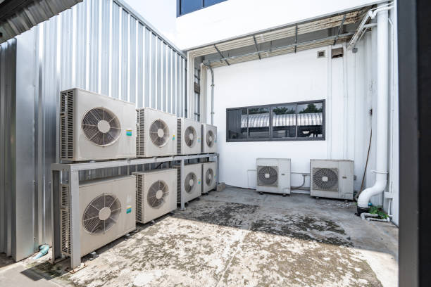 istock Air conditioning system on ground side of habitat. Multiple white compressor air condition installed in old building.
Condenser unit or compressor on ground of building background. 1473100237