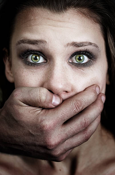 Scared woman victim of domestic violence stock photo