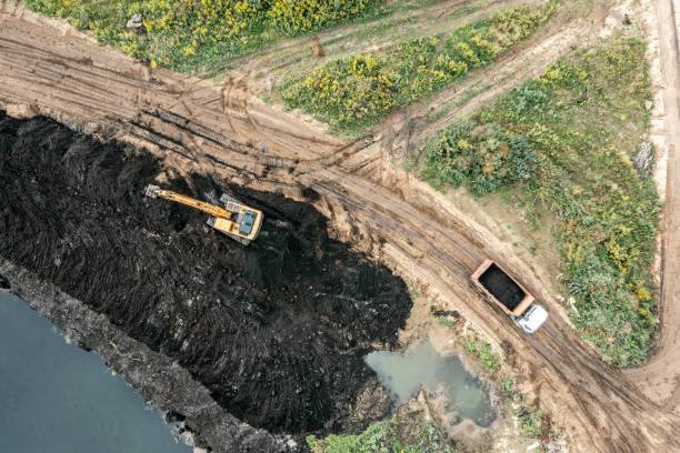 istock swamp area reclamation using heavy construction machinery. aerial top view. 1473105156