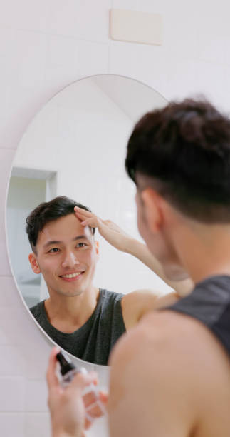 istock man use hair growing tonic 1473106457