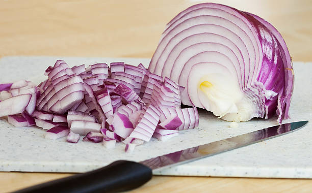 Diced Red Onions on a Chopping Board stock photo