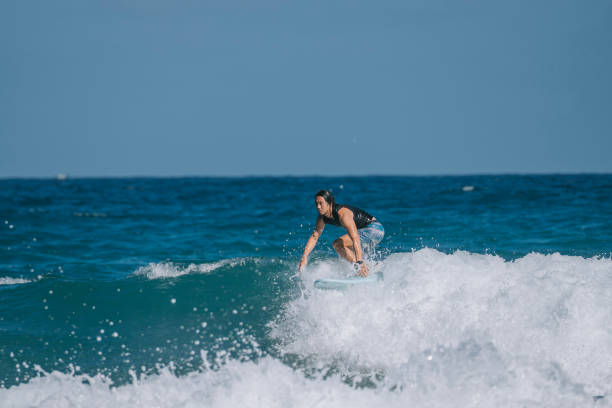 istock Asian Chinese Male Surfer riding wave in Pacific Ocean 1473107441