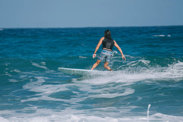 istock Asian Chinese Male Surfer riding wave in Pacific Ocean 1473107445