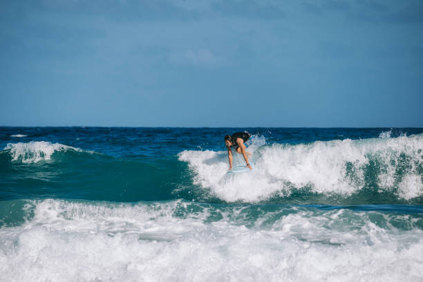 istock Asian Chinese Male Surfer riding wave in Pacific Ocean 1473107449