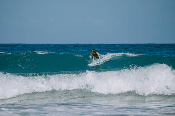 istock Asian Chinese Male Surfer riding wave in Pacific Ocean 1473107464