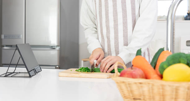 istock man in his 40s cooking in the kitchen using a tablet 1473107761