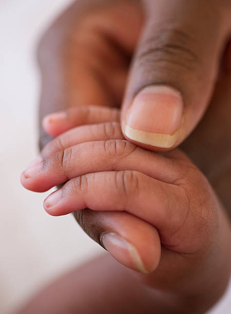 infant hand in mother's