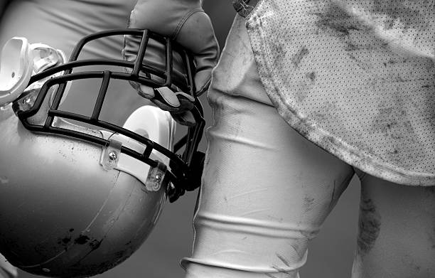 istock A footballer in uniform holding a helmet 147310940