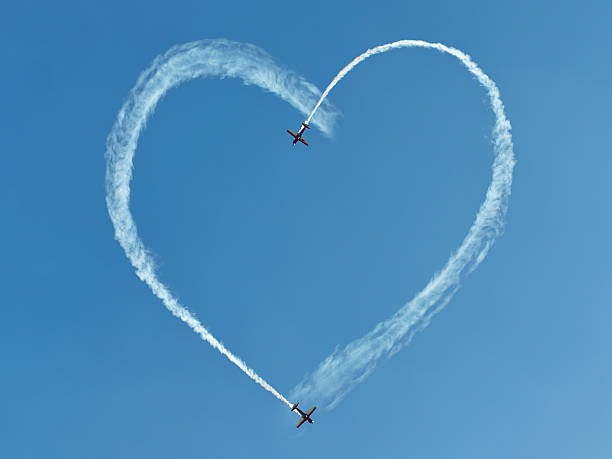 istock Two airplanes drawing heart into the sky 147311071