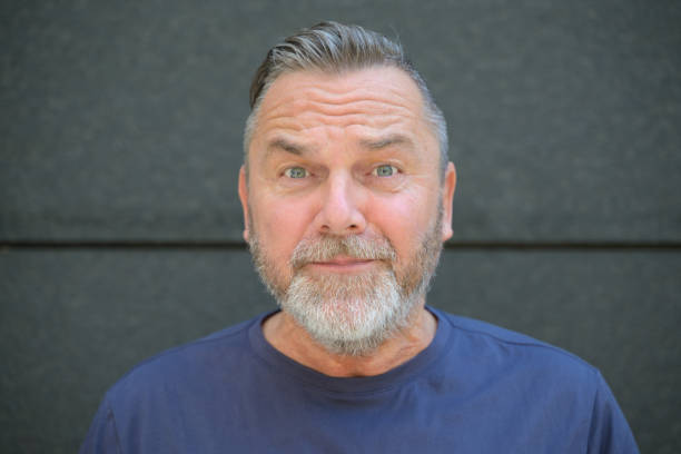 istock Bearded middle aged man staring at camera in consternation 1473113176