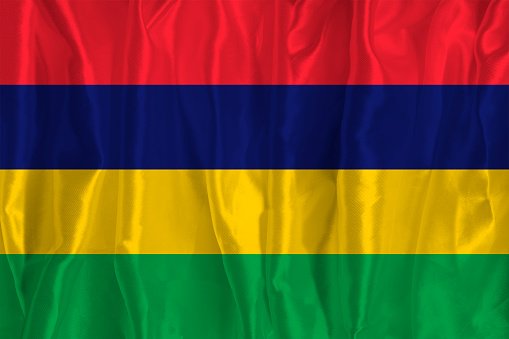 The flag of Mauritius on a silk background is a great national symbol. Texture of fabrics The official state symbol of the country