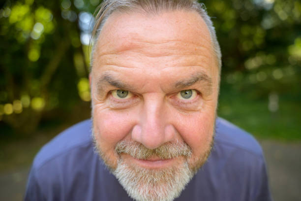 istock Smiling middle aged man leaning in towards the camera 1473114271