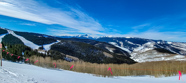 Skiers enjoying a beautiful day on Vail Mountain, Vail, Colorado, Views of Vail Mountain from the Ski Slopes, looking into the out of bounds area from a ski slope