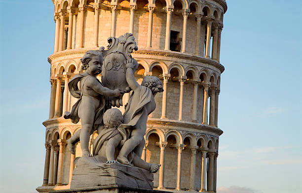 istock Pisa - statue of angels and hanging tower 147311444