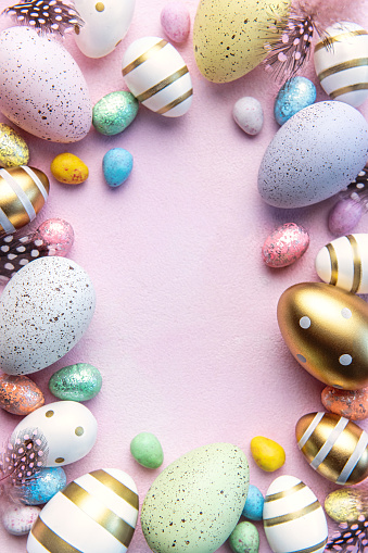 Happy Easter concept. Flat lay Easter eggs on  pink concrete background. Top view with copy space.