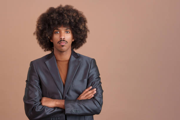 istock Serious stylish african man wearing a jacket looking at camera 1473116945