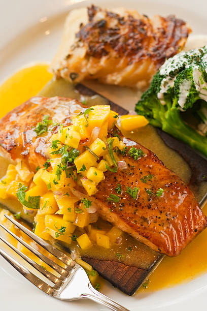 istock cedar plank cooked salmon, mango salsa, broccoli and potato 147311695