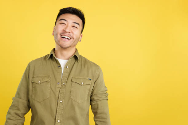 istock Chinese man laughing and looking at camera 1473117073