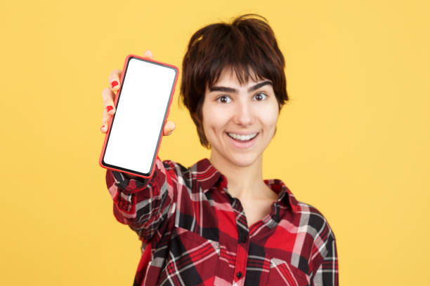 istock Androgynous person showing a blank mobile screen 1473117223