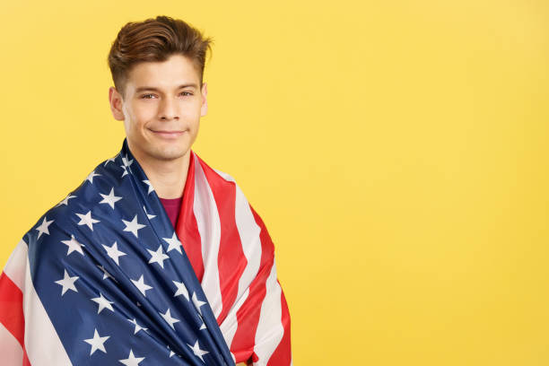 istock Proud man wrapping with a USA flag 1473117243