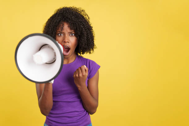 istock Angry African woman shouting using a megaphone 1473117847