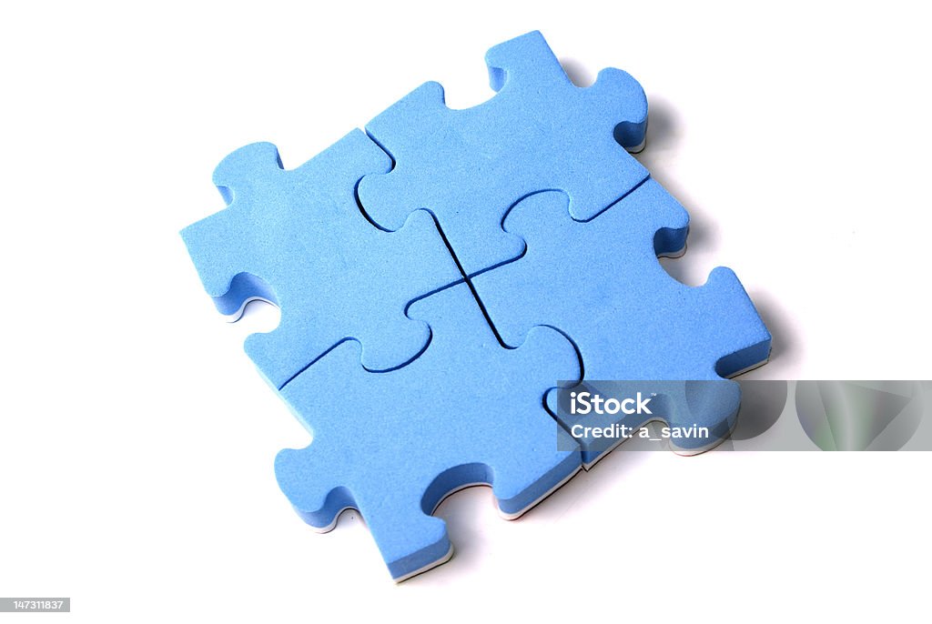 Puzzles Four attached blue puzzles isolated over white Attached Stock Photo