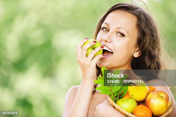 Portrait Of Young Attractive Brunette Woman Eating Apple Stock Photo - Download Image Now