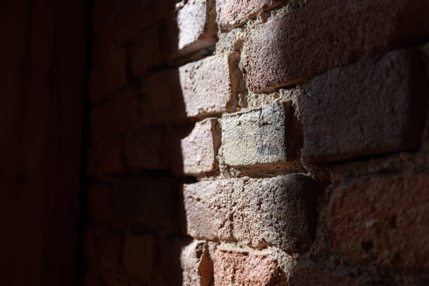 Brick wall with streaks of light and shadows