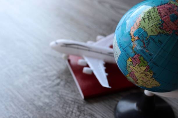 istock Selective focus image of world globe, toy plane and passport with copy space 1473125547