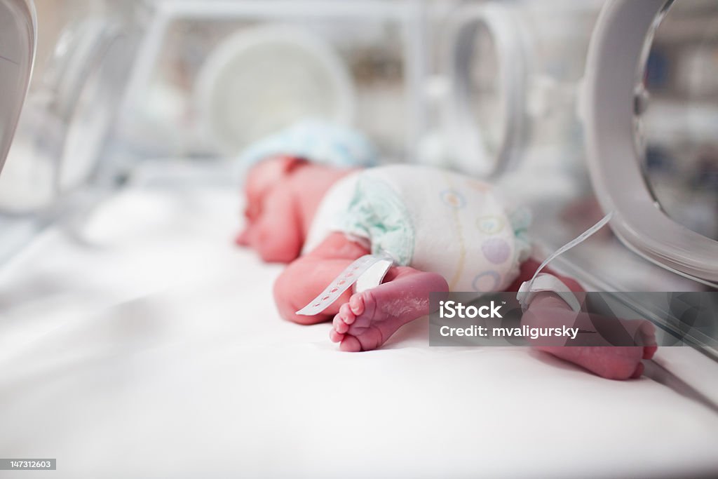 Newborn baby boy covered in vertix inside incubator Baby - Human Age Stock Photo