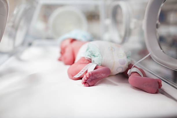 newborn baby boy covered in vertix inside incubator - kuvös bildbanksfoton och bilder