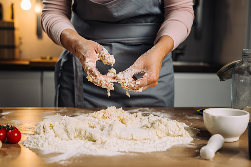 woman making dough in home kitchen