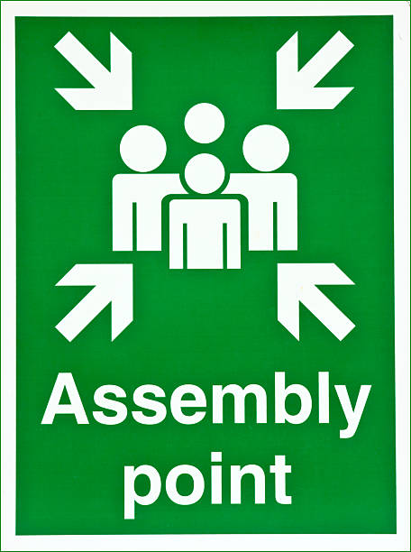 istock Green sign that says Assembly point with people icons 147312936
