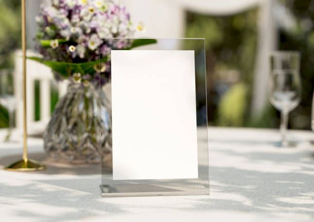 istock Mockup white blank space card, for greeting, table number, wedding invitation template on wedding table setting background. with clipping path. 1473130358