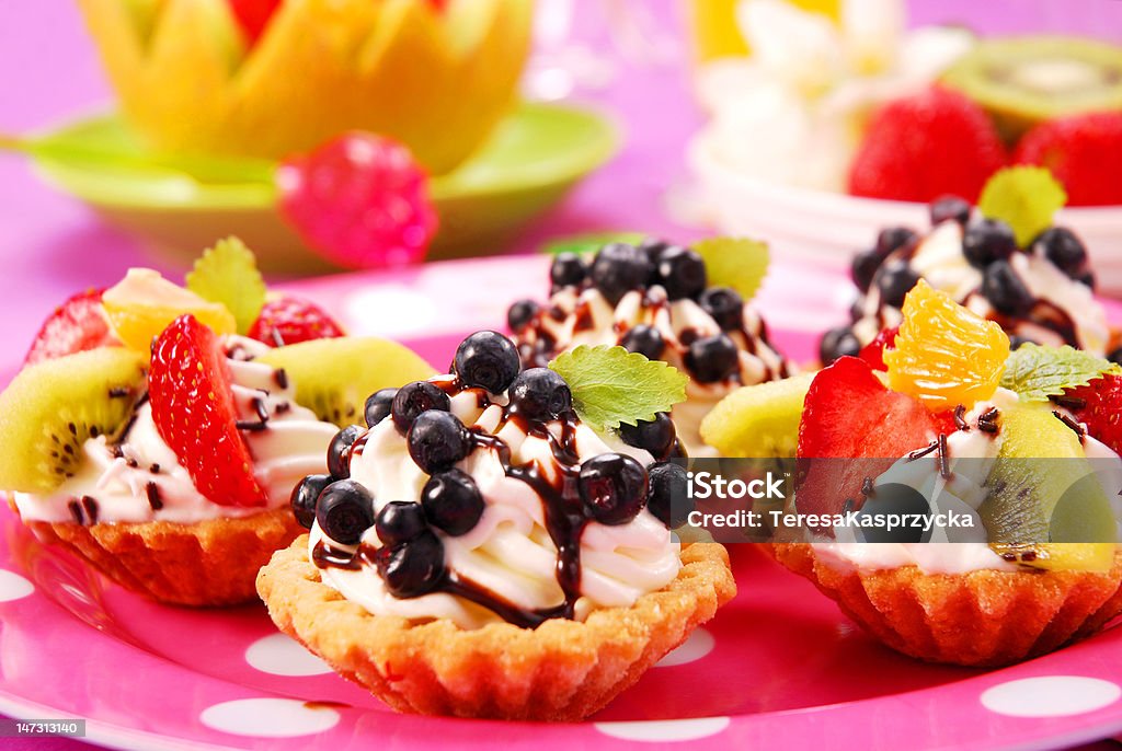 mini tartlets with cream and fruits mini tartlets with whipped cream and  fresh fruits Baked Stock Photo
