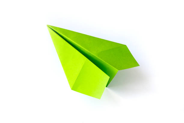 istock Green paper plane origami isolated on a white background 1473131816