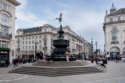 London, England - February 10, 2023: People and traffic in Piccadilly Circus in London. A famous public space in London's West End, it was built in 1819.
