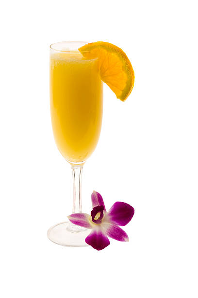 Champagne glass full of mimosa with a slice of orange stock photo