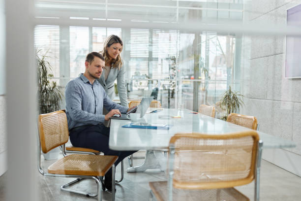 istock Young business colleagues working on laptop in the office. 1473134731