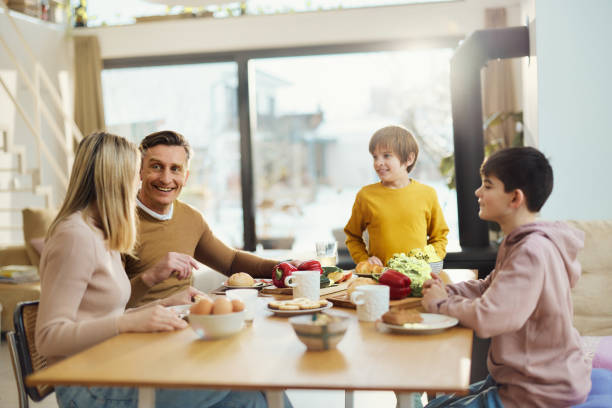 istock Happy family talking during a meal at dining table. 1473135410
