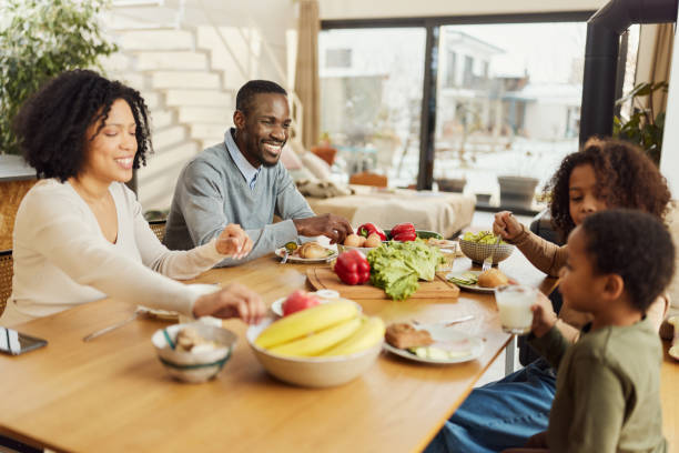 istock Happy black family enjoying in a meal at dining table. 1473136592