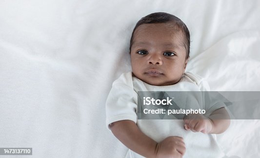 istock Portrait of close up black African American baby face sleep tight peaceful, hospital daycare nursery for new born baby. Love family healthcare and medical, mother or father's day, love tender concept 1473137110
