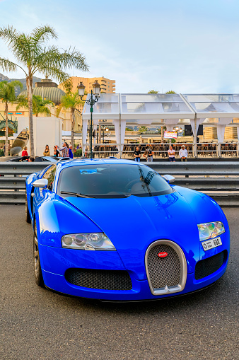 Monte Carlo, Monaco - May 27, 2022: Blue Bugatti Veyron 16.4 Luxury Supercar in front of the famous Monte Carlo Casino and Hotel de Paris