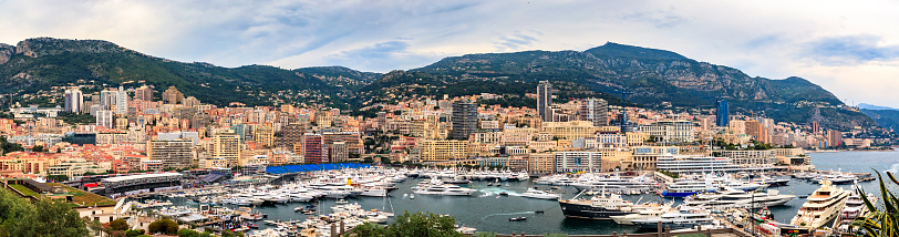 Monaco, Monaco - May 27, 2018: Panoramic view of expensive luxury yachts and apartments in the Monte Carlo Harbor on the French Riviera