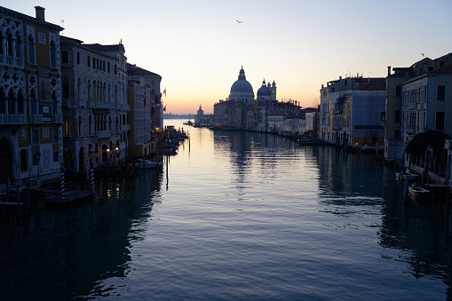 Morning atmosphere over the Grand Canal in Venice with view of Santa Maria della Salute just before sunrise.